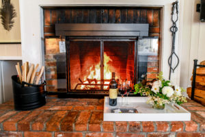 Wine, flowers and a warm fireplace.