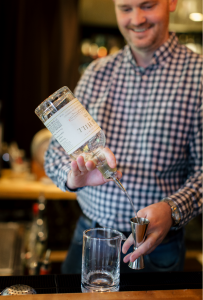 Bartender pouring a mixed drink.