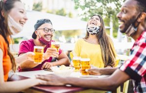 Photo of a Group Laughing and Drinking Beer at a Stowe Brewery.