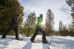 Photo of a Couple Snowshoeing near Edson Hill, the Best Vermont Winter Vacation Destination.