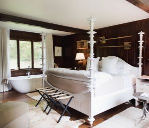 Guest room with soaking tub and four post king bed