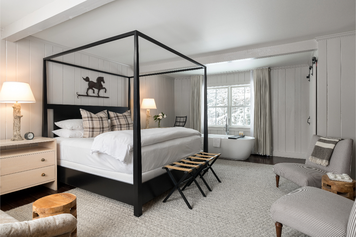 Book Now Stay Later Guest House bedroom with tub.