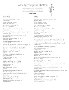 A wine menu organized in columns, featuring white wines on the left, reds on the right, and sparkling/rosé below whites. Each menu section lists wine names, regions, and prices by the glass or bottle.